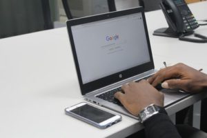 person typing on a laptop in google chrome