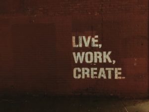 live, work, create painted on a brick wall