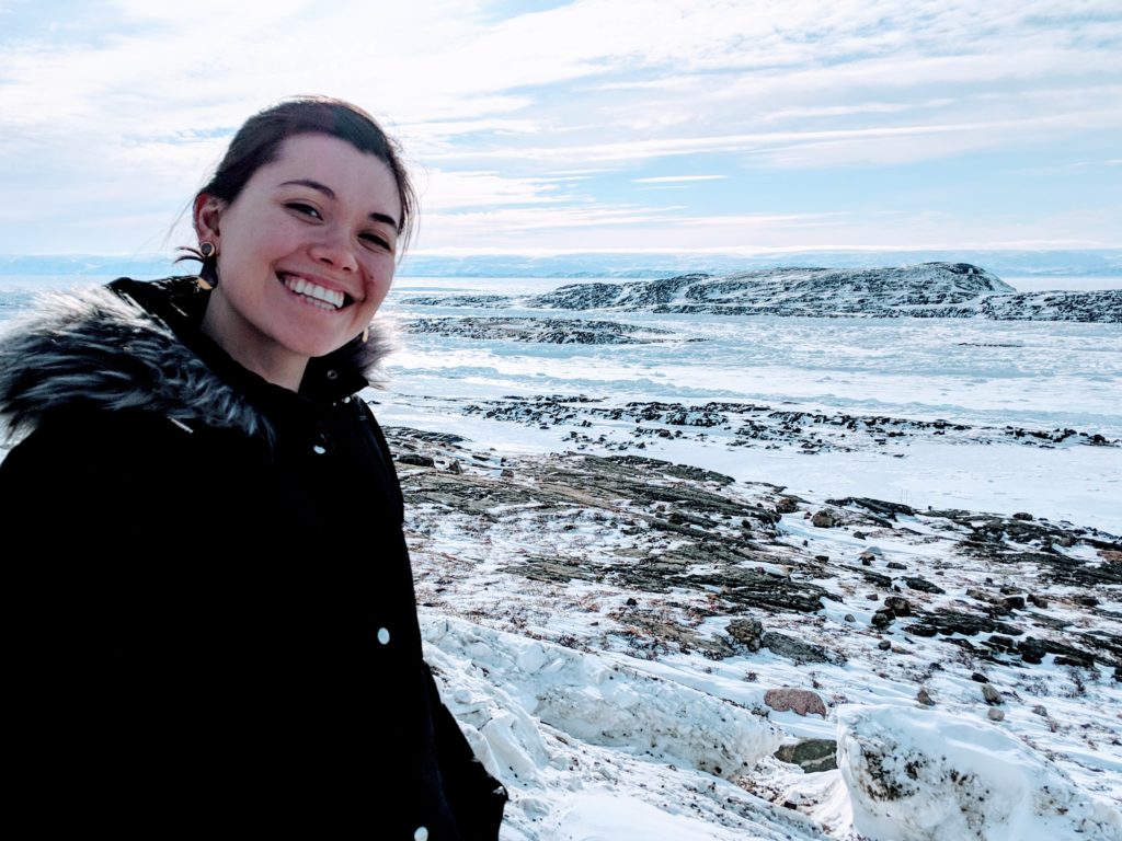 Danielle Moore in front of a beautiful winter landscape