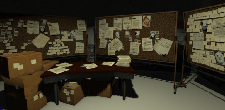 An office room with different bulletin boards and a desk with boxes