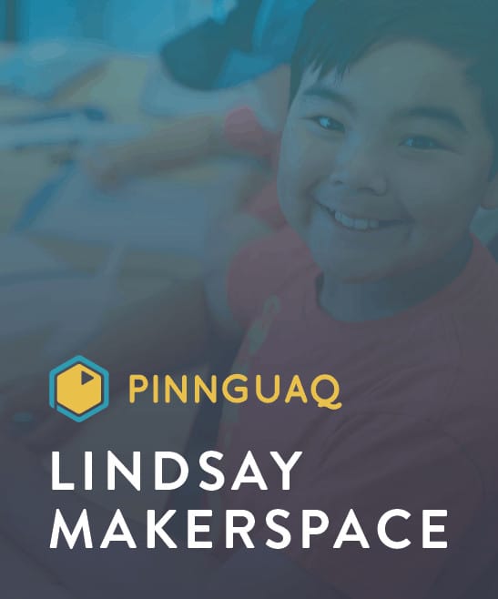 a kid smiling at the camera with pinnguaq lindsay makerspace written on the bottom left corner of the picture