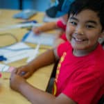 A student smiling at a camp at the Iqaluit Makerspace.