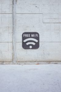 free wifi symbol in the middle of a white a brick wall
