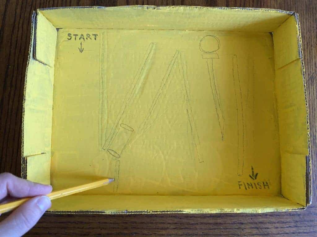 A person sketching into a yellow box.