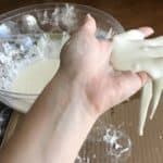 A hand holding oobleck.