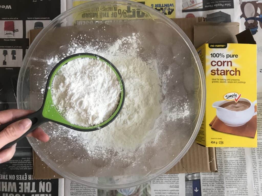 Cornstarch being poured into the bowl.
