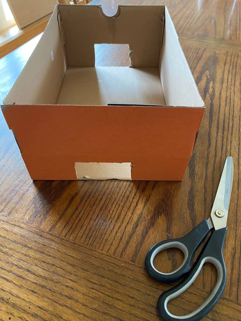 A box with two squares cut out from each end.