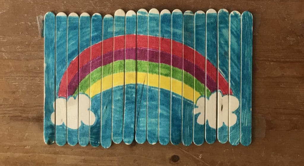 A rainbow puzzle made with popsicle sticks.