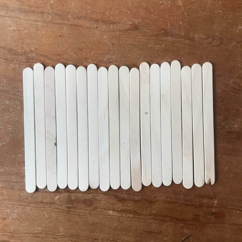 Popsicle sticks laying side by side.