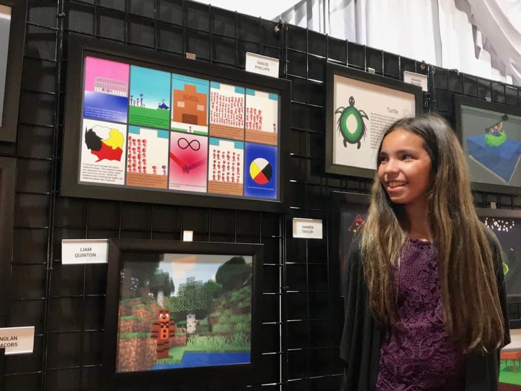 student standing in front of artwork 