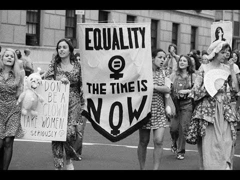 Women holding up protest signs to fight for their rights in the 60s and 70s.